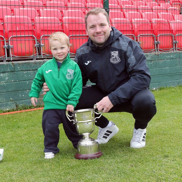 Villa manager Conor Coad pictured with his son Reuben after leading the club to a historic first Munster Junior Cup title. Villa manager Conor Coad pictured with his son Reuben after leading the club to a historic first Munster Junior Cup title.